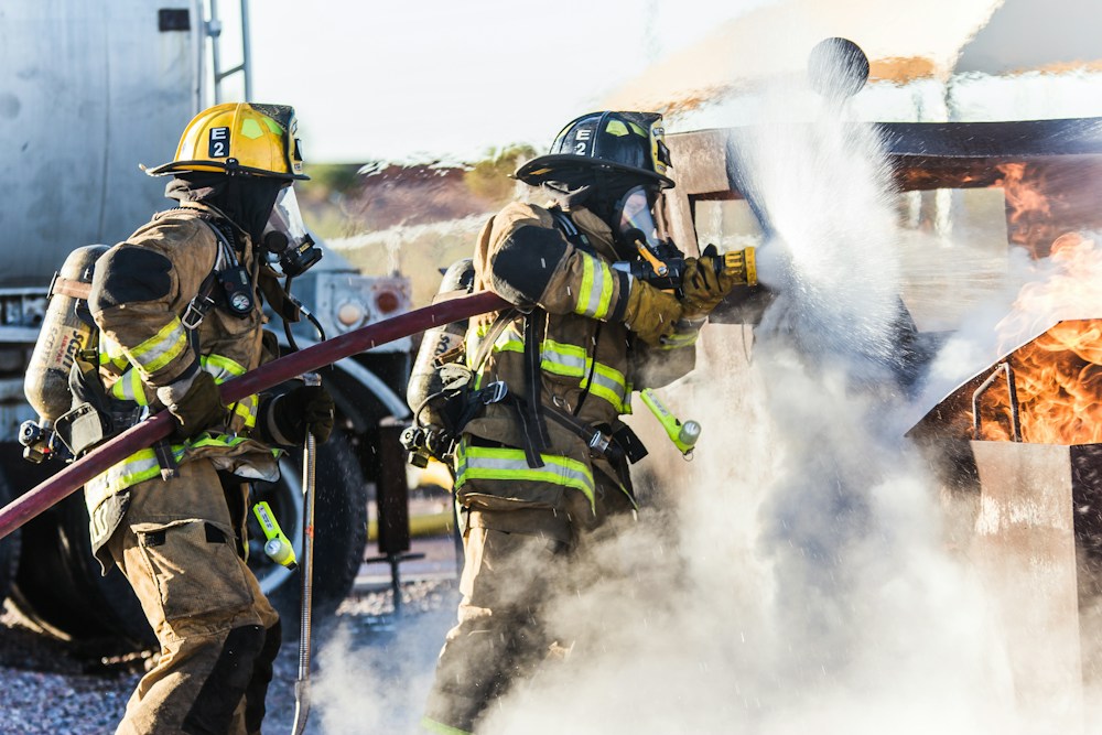 Firefighters working a hose during training
